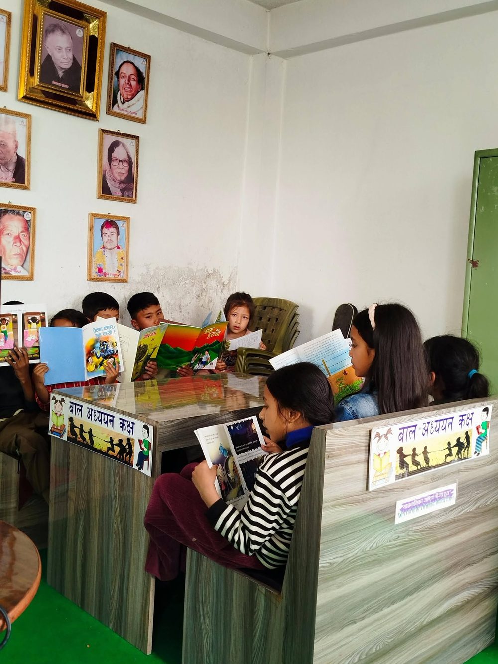 Children reading picture books together in KMRDL's children's reading corner