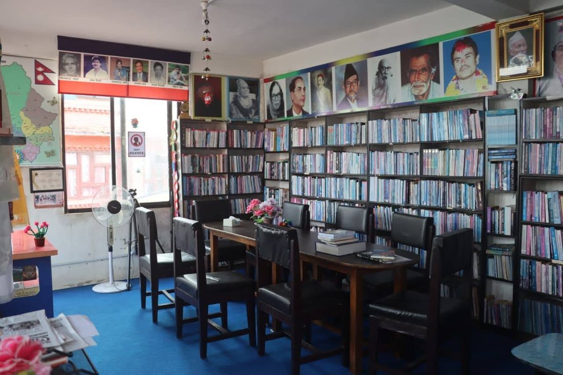 A reading room at KMRDL with tables, chairs and shelves of books